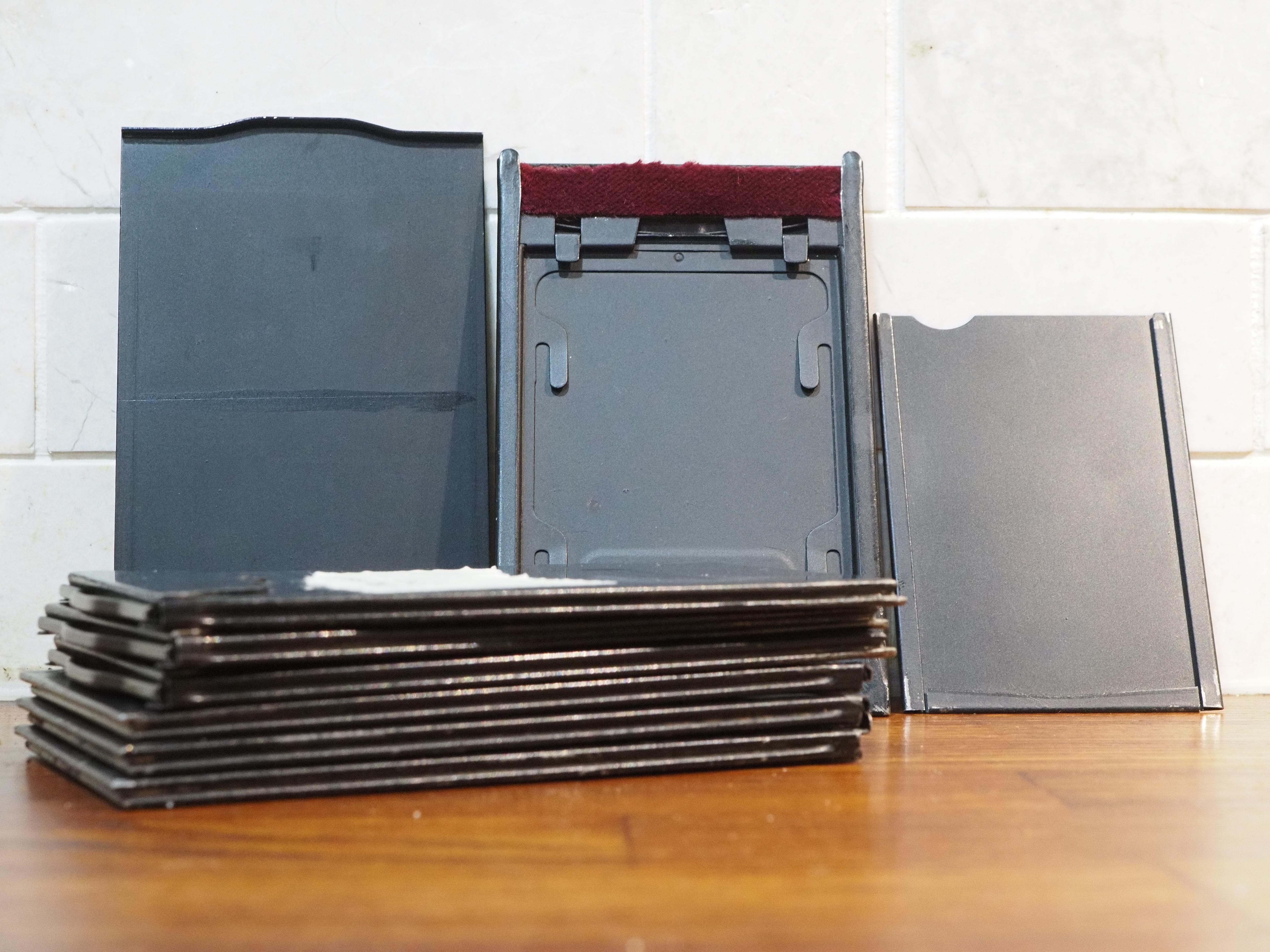 Glass plate holders. The light seals are made from a very long red felt. Also shown is a film sheet insert for one of the holders.